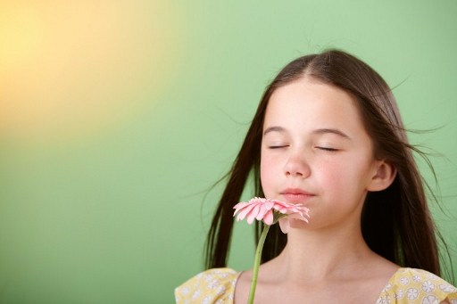Girl sniffing flower