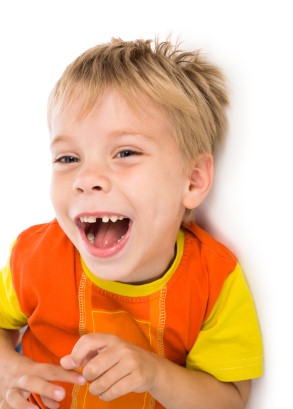 little expressive laughing boy lie on white background